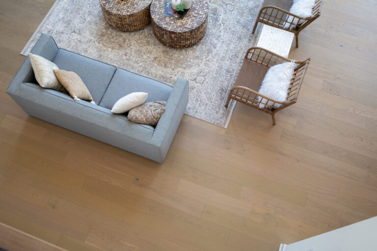 above view of living room white oak hardwood floor with couch area rug and chairs
