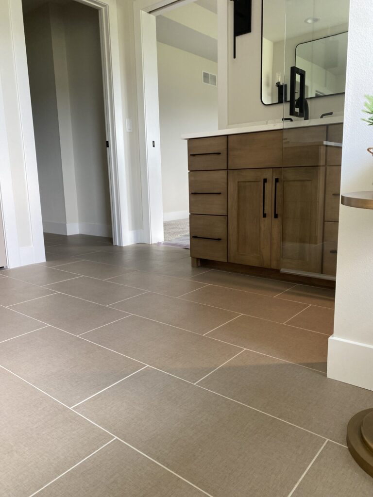 large tan color tile bathroom floor