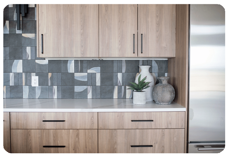 alternating patterns on graphite color art pottery style tile in a kitchen backpslash installed counter to ceiling