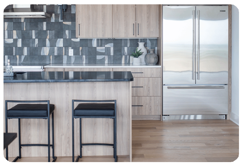 alternating patterns on graphite color art pottery style tile in a kitchen backpslash installed counter to ceiling
