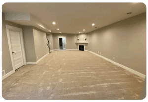 beige wall to wall carpeting in a large lower level living space with no furniture
