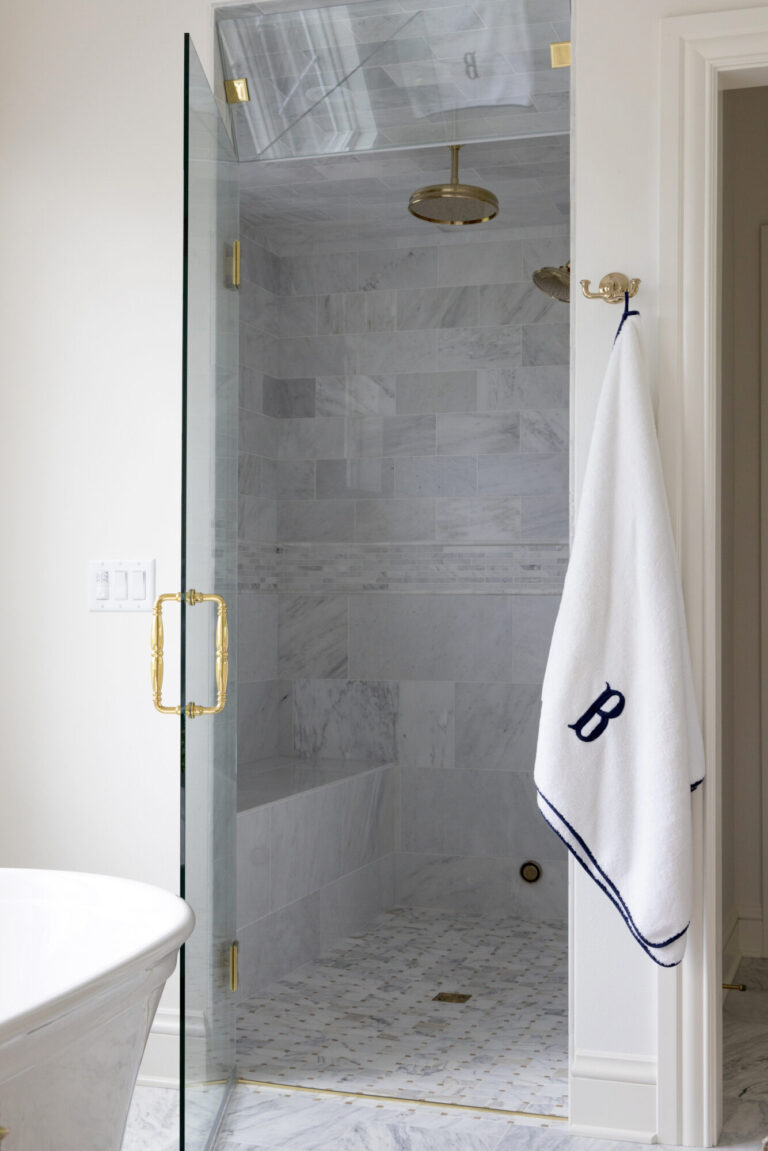 walk in shower with grey marble tile on shower wall and floor