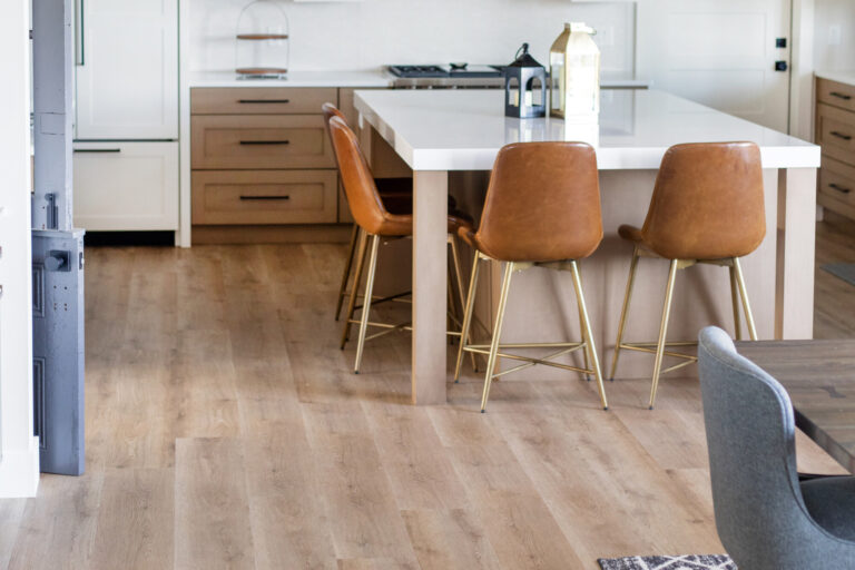 kitchen floor luxury vinyl plank wood look with brown chairs pulled up to a white island