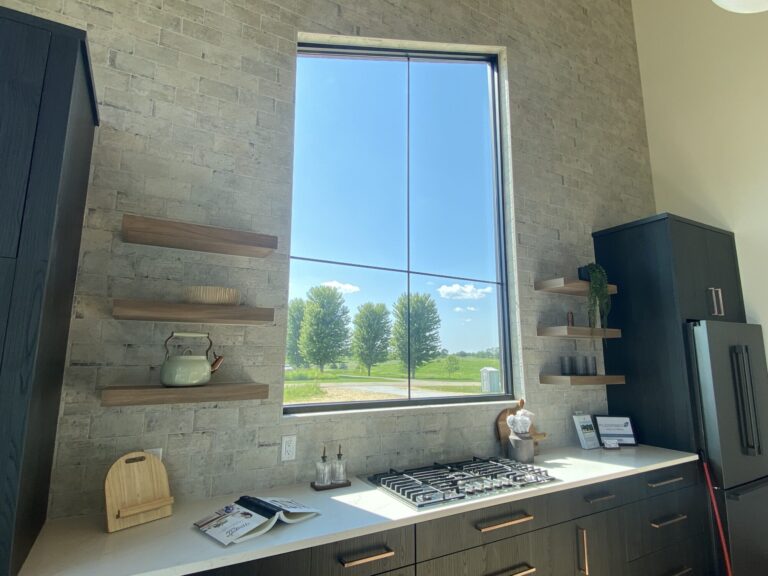 close up of kitchen backsplash installed counter to ceiling textured tile with high window