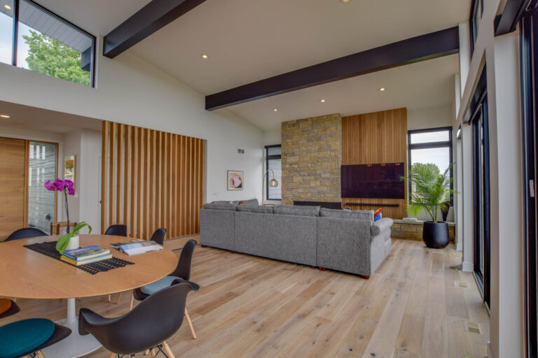 white oak hardwood floor living room with tables and chairs and grey couch