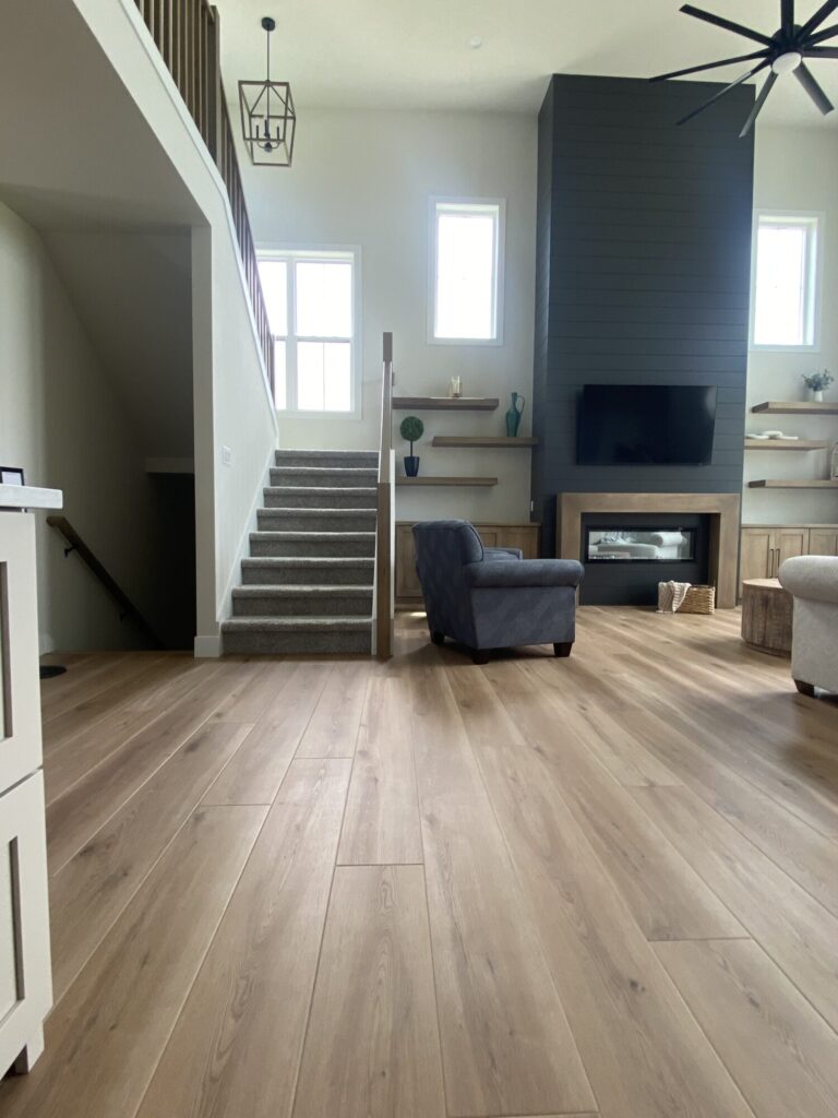 view of living room and staircase with a two story grey tile fireplace