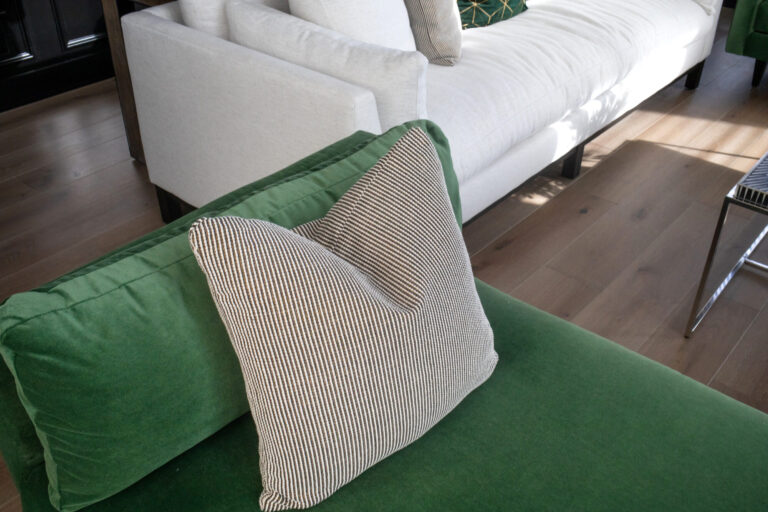 green couch and white couch on hardwood flooring in the living room