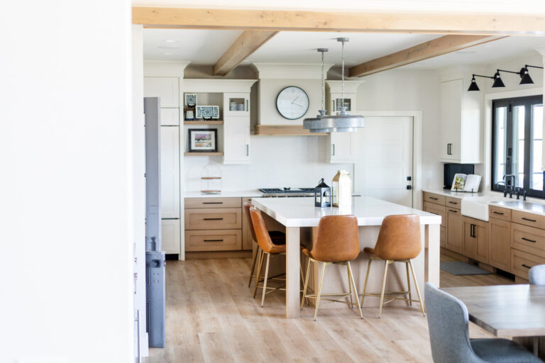 wide view of kitchen with white walls luxury vinyl plank wood look floors with white and wood cabinetry