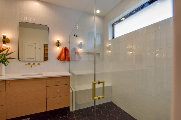 white tile shower wall black tile floors long narrow window on the long wall