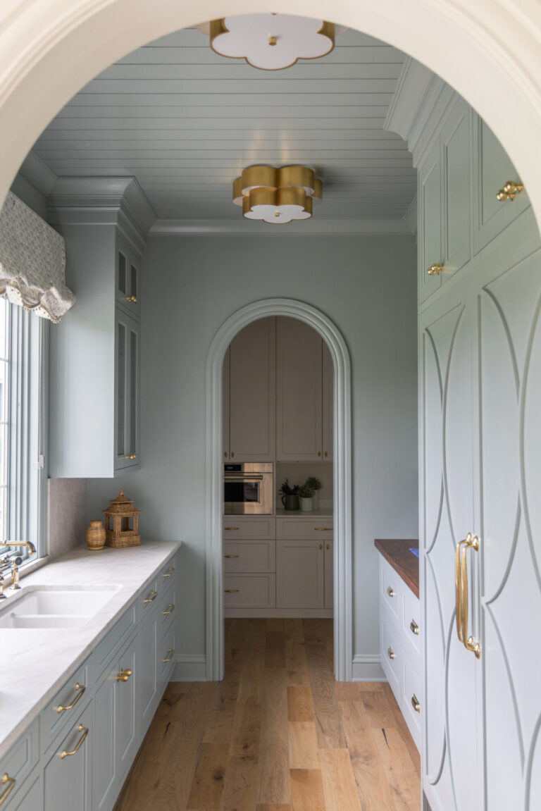 hardwood floor in butler pantry seen through an arch