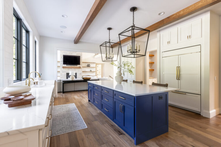 ktichen with blue island hardwood floor and white cabinets