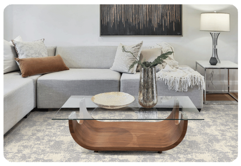 living room with grey couch and coffee table sitting on a grey and cream abstract pattern area rug