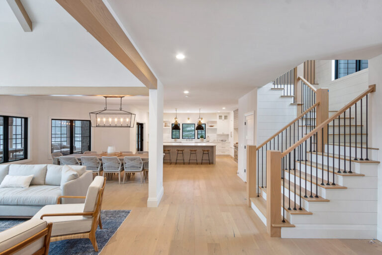 hardwood flooring in living room couch and stairs going up