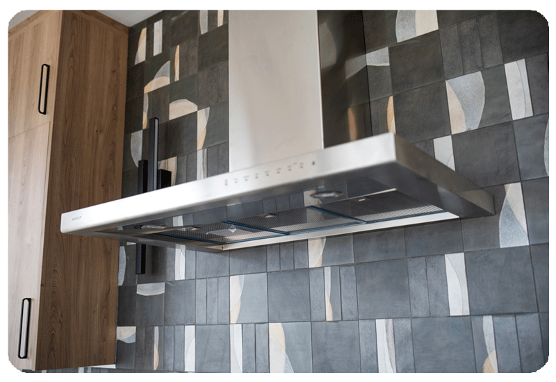 alternating patterns on graphite color art pottery style tile in a kitchen backpslash installed counter to ceiling