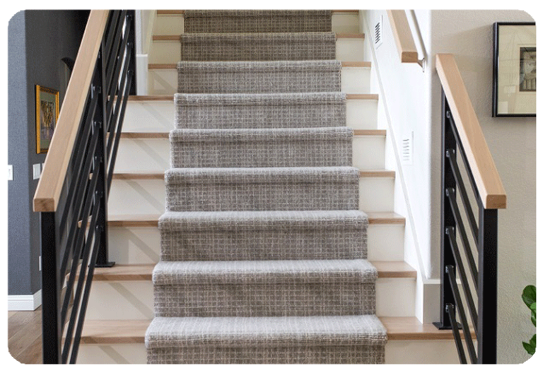 grey carpet stair runner with white and wood stairs and black and wood handrail