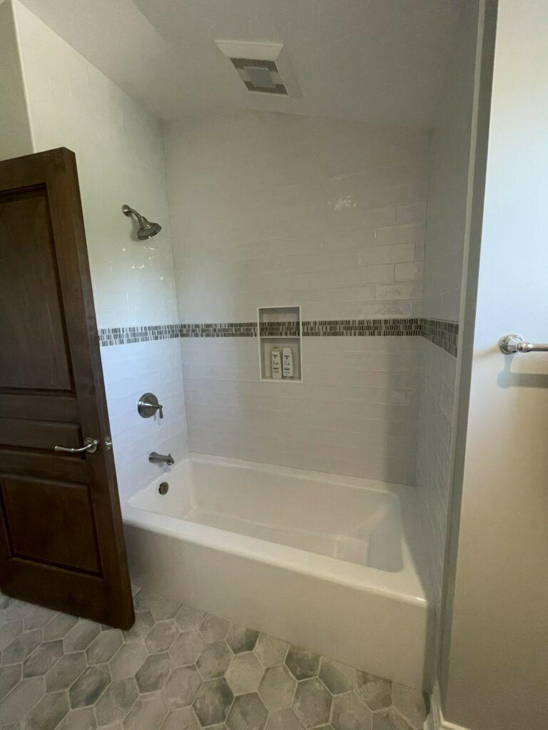 white tile bathtub shower wall