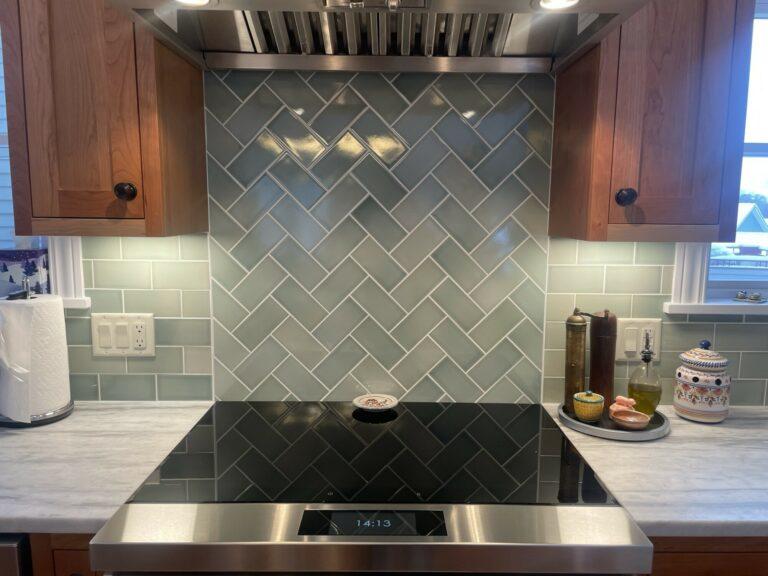 herringbone green tile kitchen backsplash