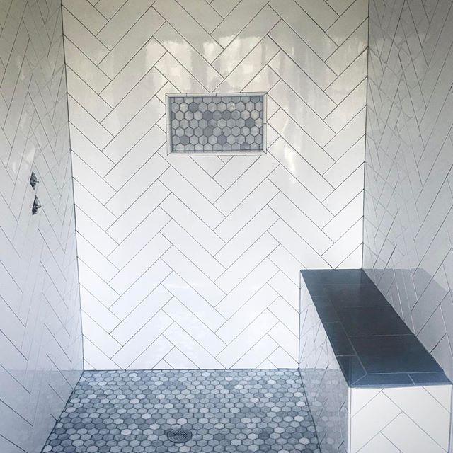 herringbone tile shower wall