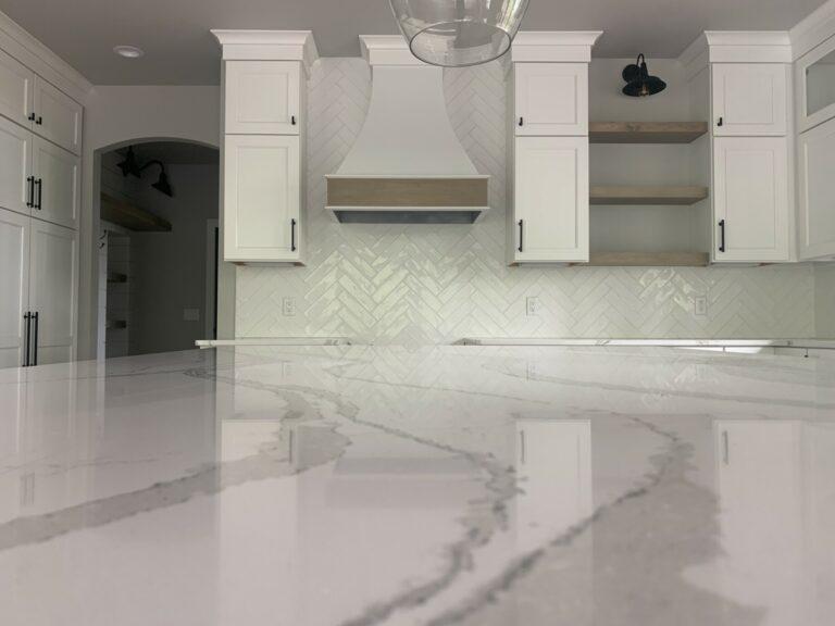 white tile herringbone installation backsplash