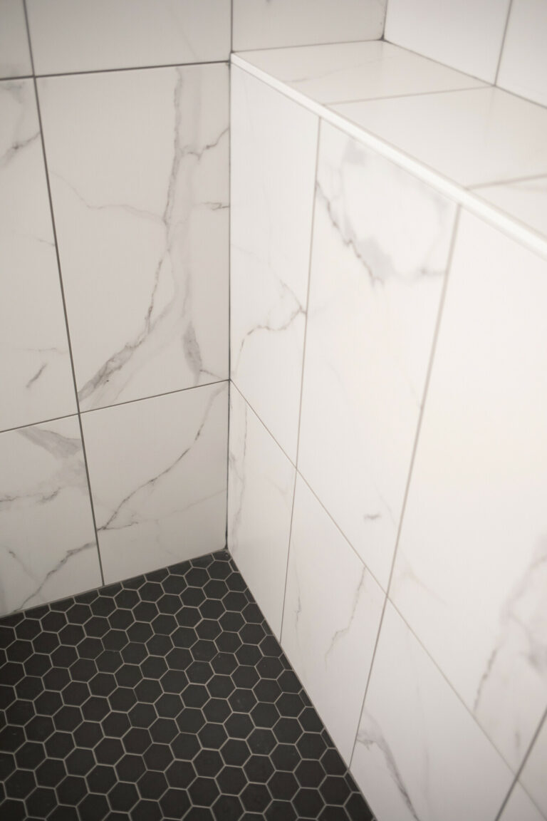 white marble tile shower wall