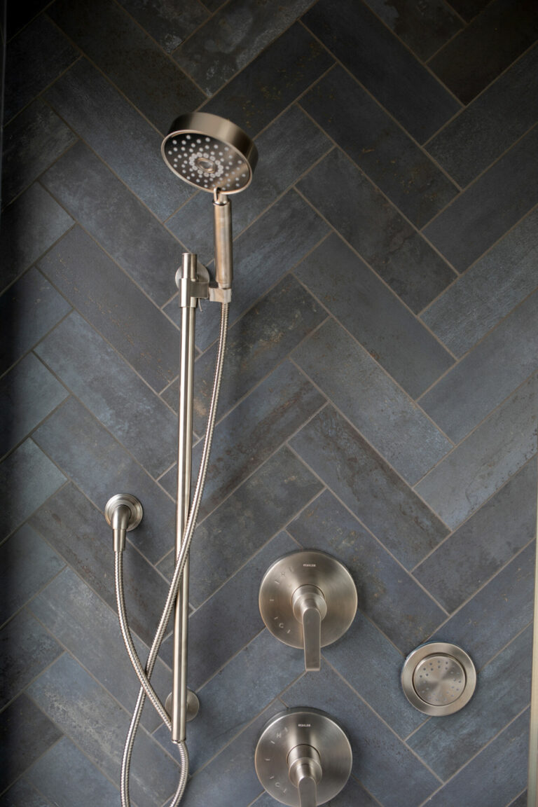 charcoal grey color shower tile herringbone pattern