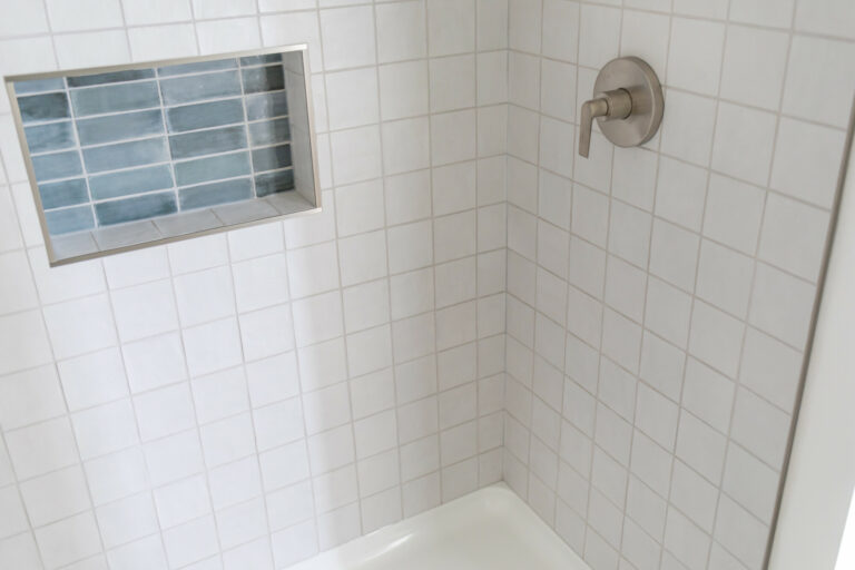 white tile wall shower green tile niche