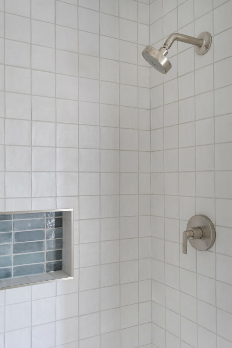 white tile shower wall green tile shower niche