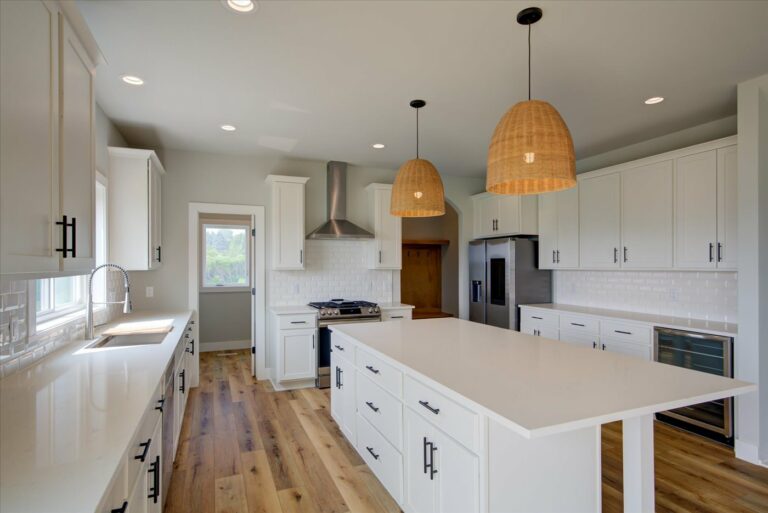 white kitchen luxury vinyl plank floor with white tile backsplash