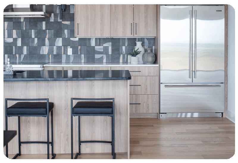 alternating patterns on graphite color art pottery style tile in a kitchen backpslash installed counter to ceiling
