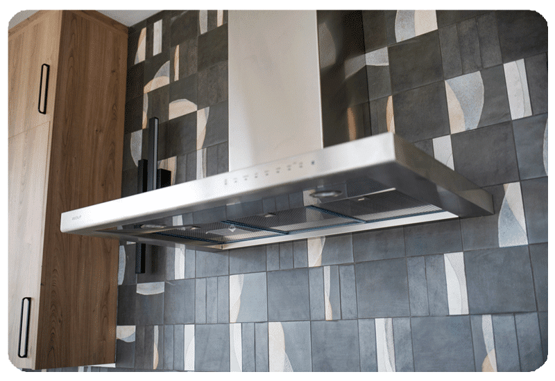 alternating patterns on graphite color art pottery style tile in a kitchen backpslash installed counter to ceiling