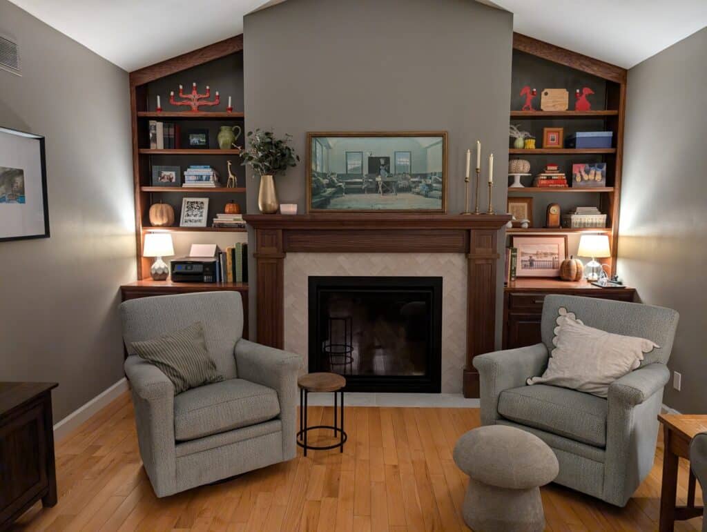 fireplace with wood mantel and white tile surrounding the hearth