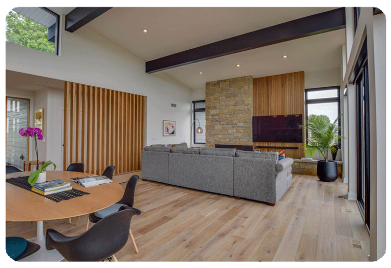 living room with grey couch hardwood floor two wood slat accent walls