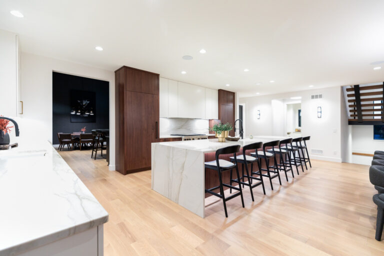 hardwood flooring white oak in kitchen with marble top island and eight chairs white and dark wood cabinets