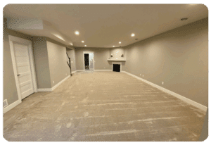 beige wall to wall carpeting in a large lower level living space with no furniture