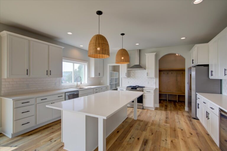 view of white kitchen cabinets and luxury vinyl plank wood look floors