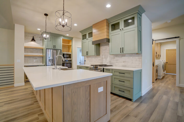 kitchen view luxury vinyl plank wood look floors with wood cabinets and green cabinets and white tile backsplash