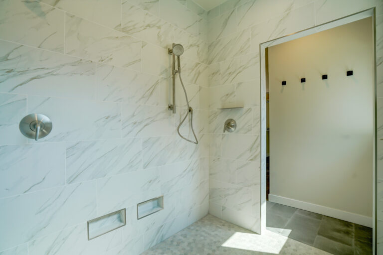 white marble tile shower room