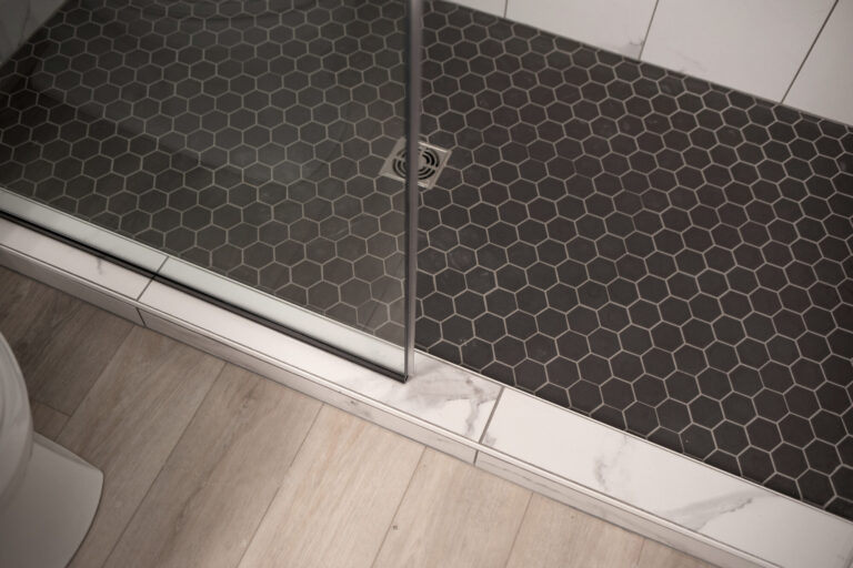 walk in shower black tile floor and white tile wall