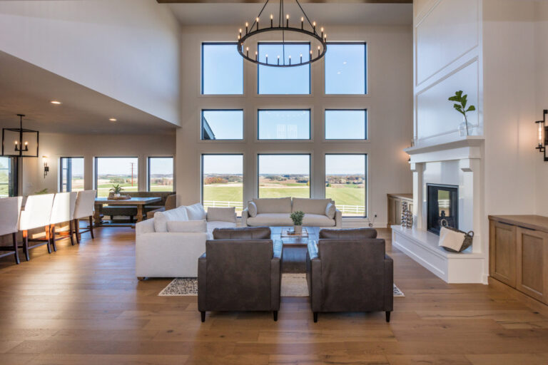 hardwood flooring in a living room and a wall of windows