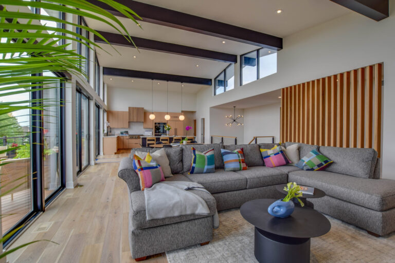 white oak hardwood flooring living room with grey sectional couch and a wall of windows