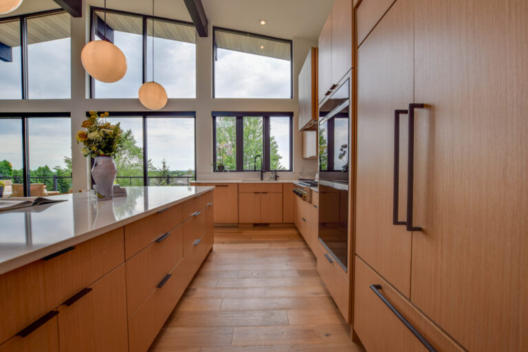 view of kitchen with a wall of windows, hardwood floor and matching wood cabinets