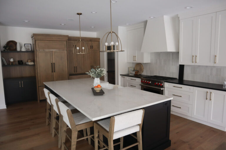 view of kitchen with hardwood flooring white island and white tile kitchen backsplash with white cabinets and stove hood