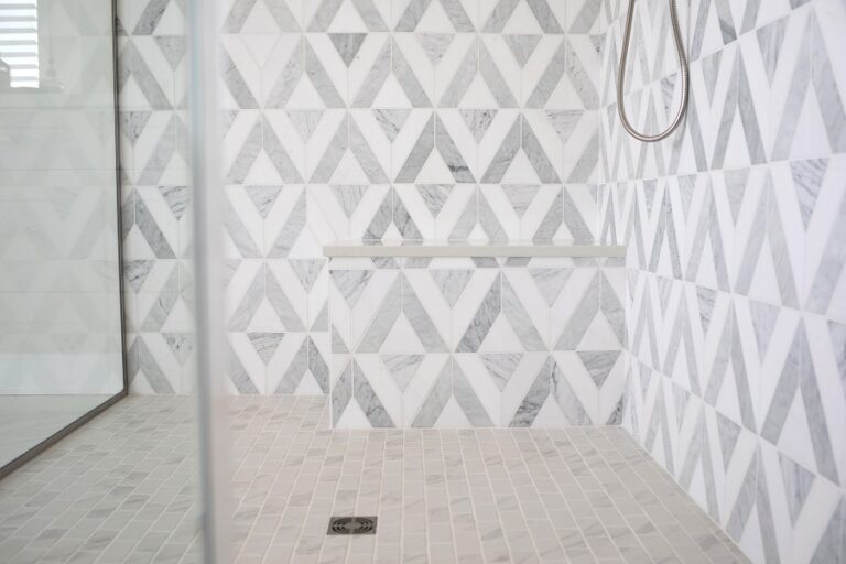 walk in shower with stone tile wall and floor