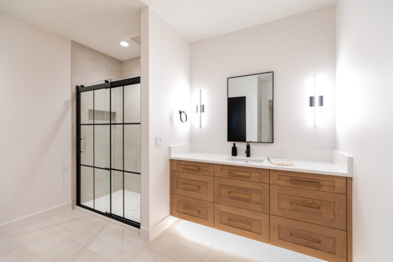 bathroom with wood single vanity marble tile floor