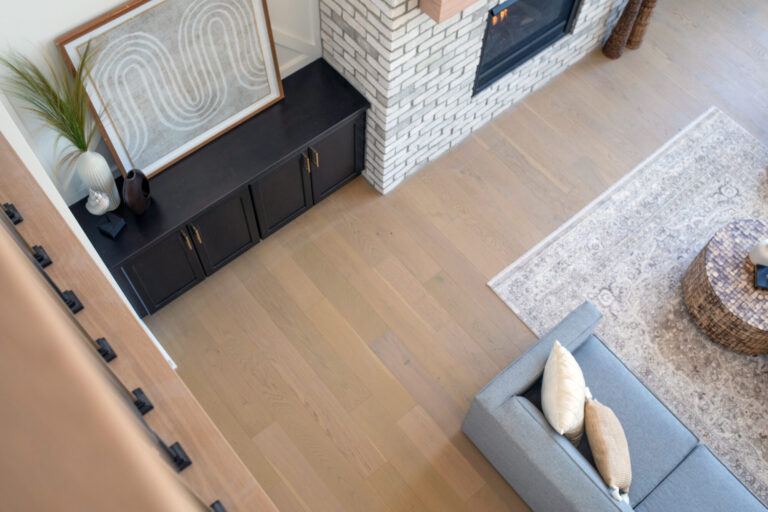 above view of living room white oak hardwood floor with part of a couch and area rug visible