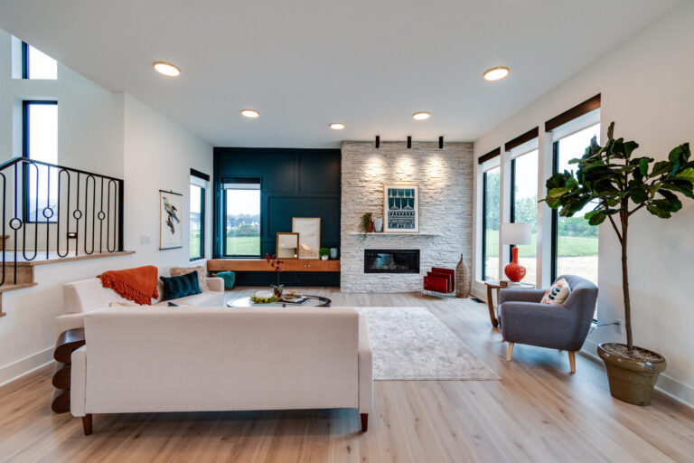 luxury vinyl plank wood look with white couch and area rug and fireplace