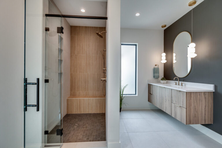 Walk in shower with brown tile floor and wood look fluted tile walls