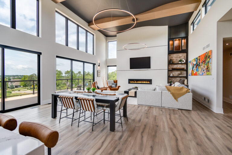 luxury vinyl plank wood look with view of marble white fireplace and table and chairs