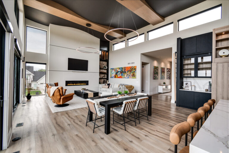 living room view luxury vinyl plank wood look table and chairs with large white fireplace