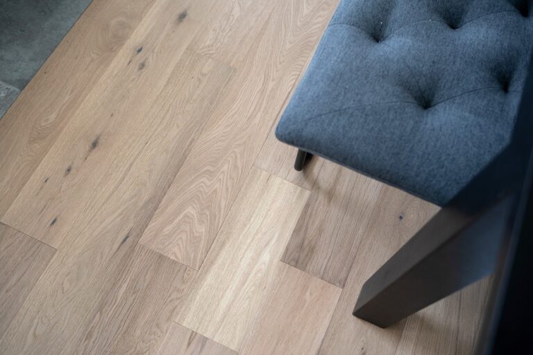 white oak hardwood flooring close up with tufted grey chair